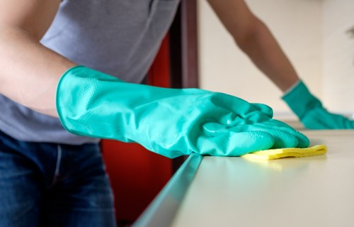 Staff managing a damp cleaning area to prevent slips